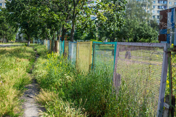 Fototapeta premium Old abandoned fence on the street