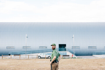 security guard in uniform and armed working on the safety of buildings