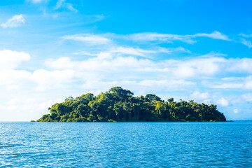 Little Green Tropical Island on clear blue water. Solentiname Archipelago, Nicaragua. Beautiful background peaceful landscape. Virgin Rain forest. View from the boat.