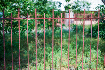 Fototapeta na wymiar Old abandoned fence on the street
