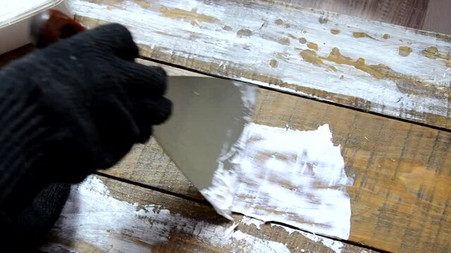 Hands of an old manual worker with wall plastering tools renovating house. Plasterer renovating outdoor walls and corners with spatula and plaster. Wall insulation. Construction finishing works - Imag