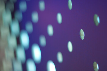 Pattern of circles with shallow depth of field on a dark blue background