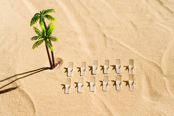Aerial view of many sunbed, lounge, palm tree on  private sandy beach. Summer and travel concept. Minimalism