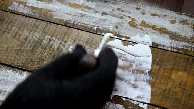 Hands of an old manual worker with wall plastering tools renovating house. Plasterer renovating outdoor walls and corners with spatula and plaster. Wall insulation. Construction finishing works - Imag