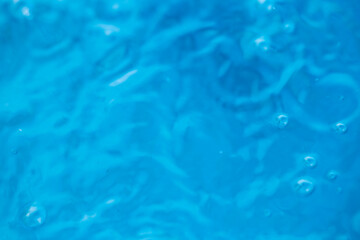 The round transparent drop of water, falls downwards. Selective focus.