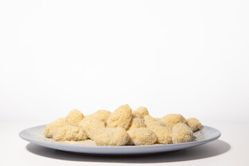 a plate with non fried croquettes isolated in a white background