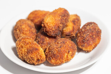 a plate with a bunch of homemade croquettes