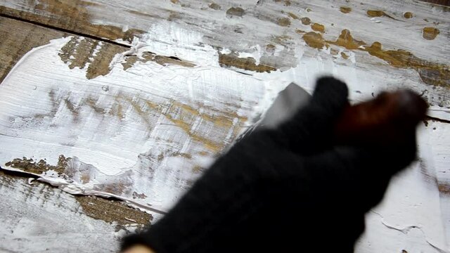 Hands of an old manual worker with wall plastering tools renovating house. Plasterer renovating outdoor walls and corners with spatula and plaster. Wall insulation. Construction finishing works - Imag