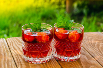 Fresh and sweet strawberry drinks on the table on a sunny day