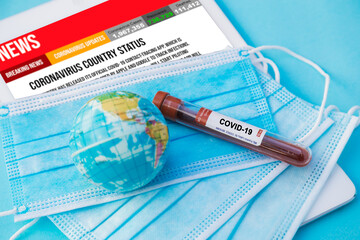 a top view of a coronavirus blood test tube and a mask 