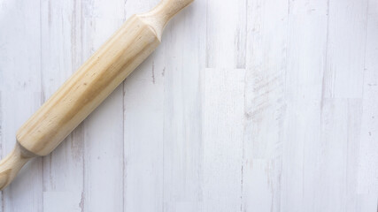 wooden roller on white wooden background
