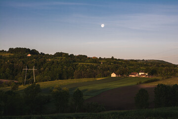 Moon over small farm in the countryside