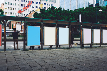 Bus station billboards with blank copy space posters for advertising text message or promotional content, empty mock up Lightbox for information, bus stop shelter clear display in urban city street © BullRun