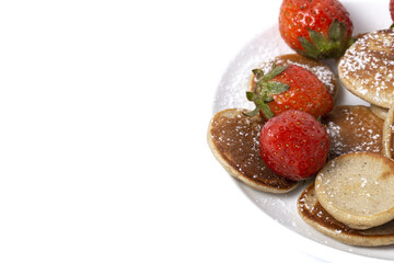 Homemade cereals mini pancake with yogurt, honey and strawberries on colorful background.
