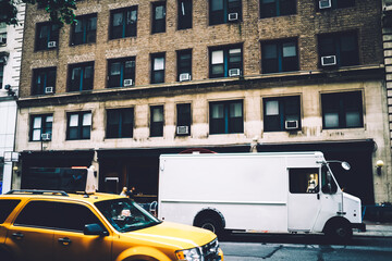 Freight van for transportation goods for delivery service moving on avenue in downtown, white truck...
