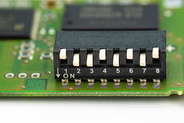 Analog switch on a green printed circuit board with eight positions, adjustable up and down.