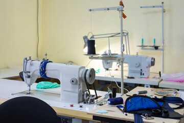 Workshop equipped with professional sewing equipment without man