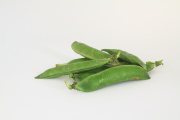 Whole green pea pods close-up isolated on a white background. Organic background with fresh juicy pea fruits