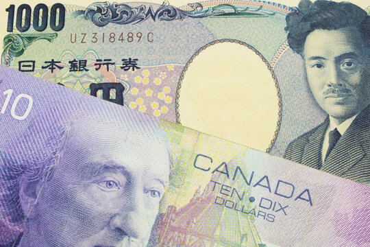 A macro image of a Japanese thousand yen note paired up with a purple ten dollar bill from Canada.  Shot close up in macro.