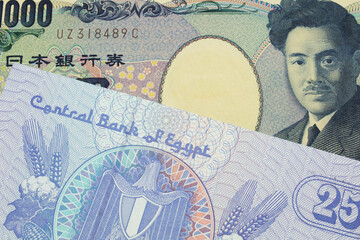 A macro image of a Japanese thousand yen note paired up with a blue twenty five piastre bank note from Egypt.  Shot close up in macro.