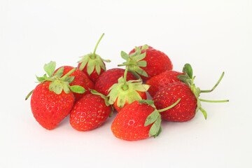 Fototapeta na wymiar Red fresh strawberries on a white background. Green leaves of strawberries. 