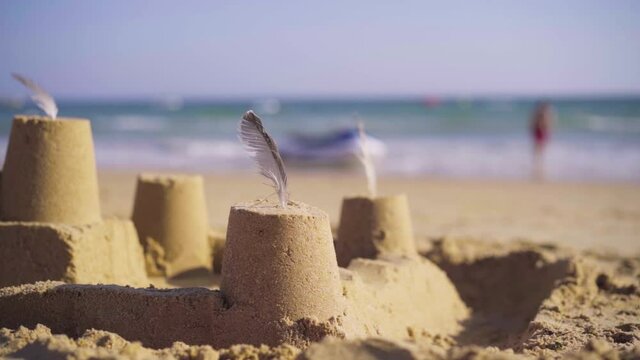 slow motion close-up shot of a sand castle on a beach