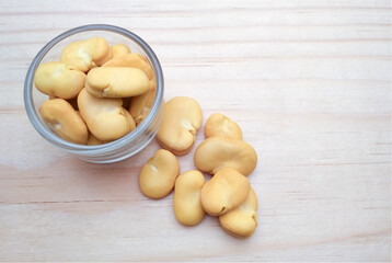  Top view broad beans, Also called Fava or Windsor Bean in glass bowl on wooden background. copy space