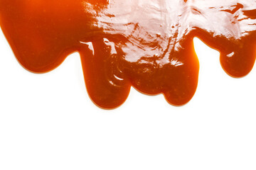 Background of flowing caramel sauce isolated on white.