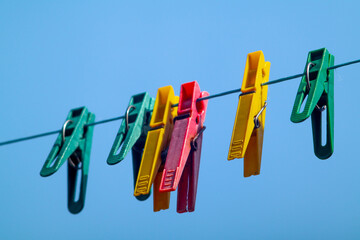 colorful clothespins hanging on a clothesline