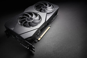 modern black computer video card on a black background, deep shadows and contrasting light, one...