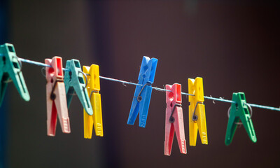 colorful clothespins hanging on a clothesline