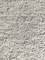 Texture of the grey plaster fur coat on the wall. Seamless texture.
