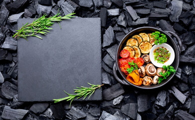Grilled vegetables on black charcoal background. Barbecue concept. copy space