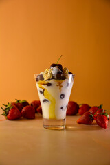 sweet cocktail with cream on orange background