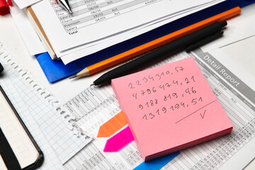 Obraz premium Top view of office employee's desk - work with financial reports, analysis and accounting, tables and graphs, various office items for bookkeeping