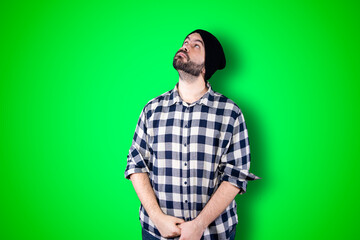 Caucasian handsome man isolated on chroma background thinking an idea while looking up