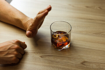 Alcoholism concept . Hands lock chain a glass of whiskey
