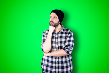 Caucasian handsome man isolated on chroma background thinking an idea while looking up