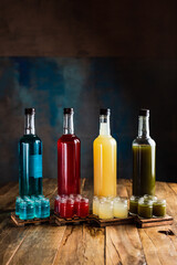 Different kinds of alcoholic shooters or shots with bottles, red, green, yellow, blue