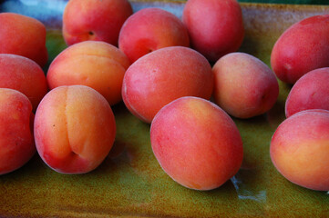 Ripe delicious apricots in a ceramic plate
