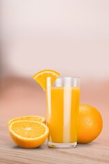 Orange juice in glass and slices of orange fruit