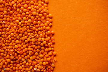 Red lentil on an orange background