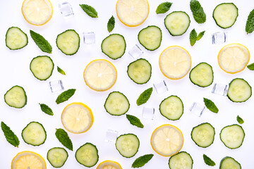 Lemonade or mohito ingredients concept on white background. Lemon slices, mint leaves , cucumber...