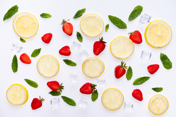 Lemonade ingredients concept pattern on white background. Lemon slices, mint leaves strawberry, and ice cubes.