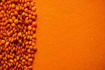 Red lentil on an orange background