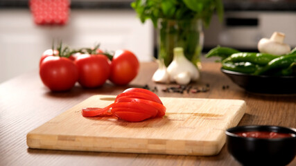 Slice tomatoes. vegetable and wooden