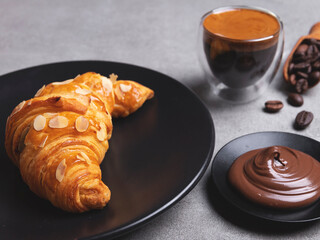 Yummy freshly three croissant sliced almonds with coffee and chocolate paste