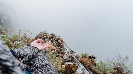 fingers folded in mudra against the background of mountains and fog, a state of peace and tranquility, Zen, yoga in nature