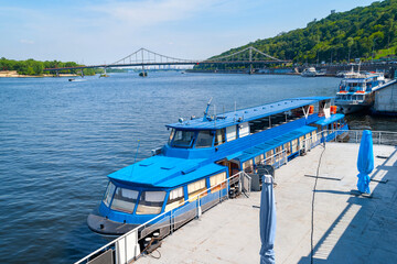 River ship at the pier. River pleasure boat moored in the port.