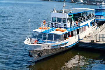 River ship at the pier. River pleasure boat moored in the port awaiting boarding of passengers.